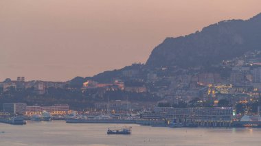 Monte Carlo 'nun şehir manzarası günden geceye geçiş zamanı, Monako yaz günbatımından sonra. Akşam sisi. Limandaki yatlar. Kaptan Martin 'den üst görünüm
