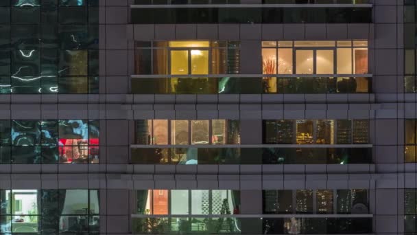 Vista nocturna del apartamento exterior timelapse edificio. Rascacielos de gran altura con luces intermitentes en las ventanas — Vídeos de Stock