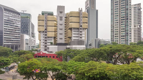 Aerial view of skyscrapers near Orchard road in Singapore timelapse. Trees and traffic on the street. Orchard road is one of best shopping district in Singapore.