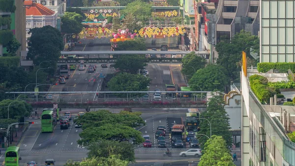 Traffic with cars on a street and urban scene in the central district of Singapore aerial timelapse. New bridge road near chinatown with skyscrapers on a background