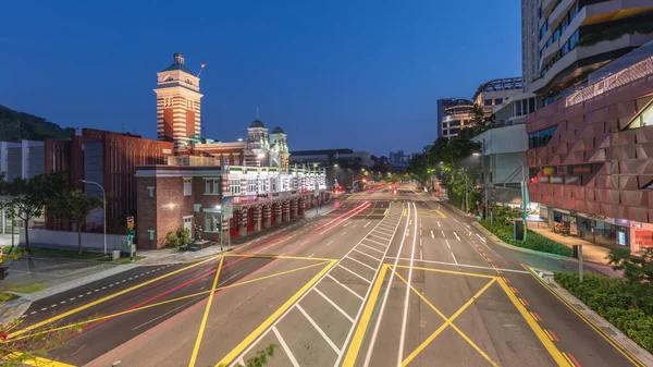 Street traffic near the fire station of Singapore night to day transition aerial timelapse. The Central Fire Station is the oldest existing fire station in Singapore on Hill street