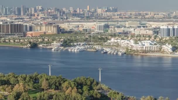 緑の公園の近くの青い運河の空中ビュードバイ市,アラブ首長国連邦｜タイムラプス — ストック動画