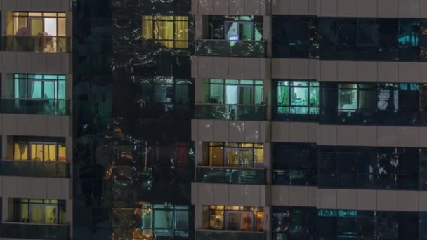 Vista nocturna del apartamento exterior timelapse edificio. Rascacielos de gran altura con luces intermitentes en las ventanas — Vídeo de stock