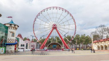 Ferris wheel in Gorky Central Park of Culture and Leisure in Kharkov timelapse hyperlapse, Ukraine. View from main alley at spring day with clouds on a sky clipart