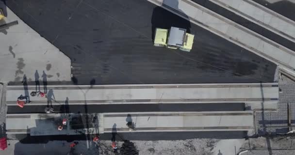 Asphalt spreading machine and vibration roller at pavement road works aerial — Stock Video