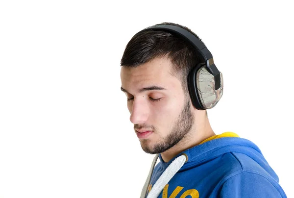 Adolescente homem relaxado ouvir música em fones de ouvido com c — Fotografia de Stock