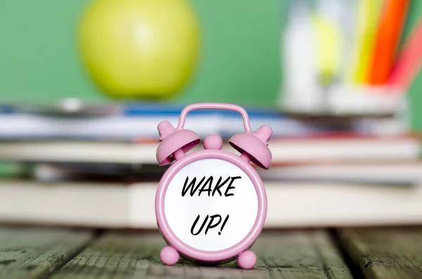 Svegliati! messaggio scritto con nero su piccolo orologio con mucchio di — Foto Stock