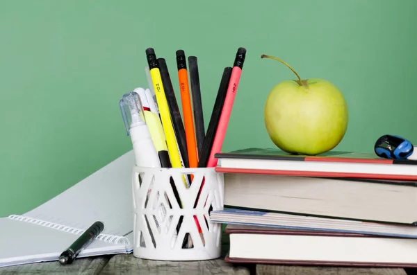 Back to school! Pile of books, green apple, open notebook, diffe — Stock Photo, Image