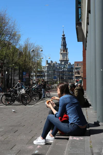 Άτομα Που Κάθονται Στις Σκάλες Στο Ηλιόλουστο Δρόμο Άμστερνταμ — Φωτογραφία Αρχείου