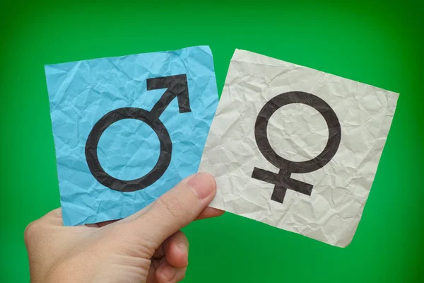 Person holding paper notes with Gender Symbols in his hand — Stock Photo, Image