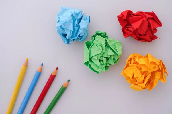 Colored pencils and colorful paper balls — Stock Photo, Image