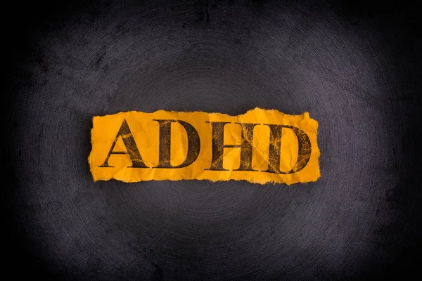 Torn piece of paper with abbreviation ADHD — Stock Photo, Image