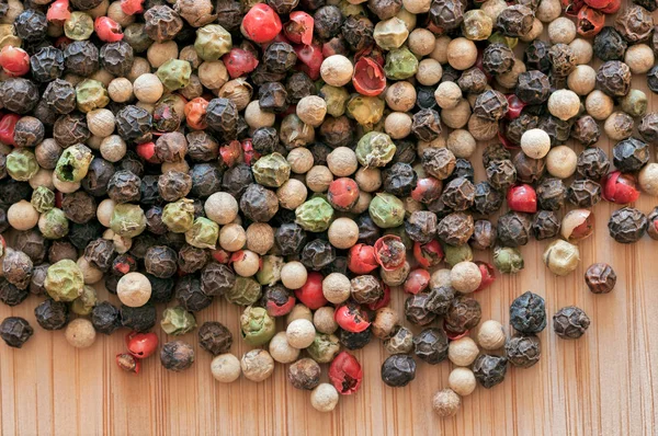 Mixed peppercorn on a wooden table — Stock Photo, Image
