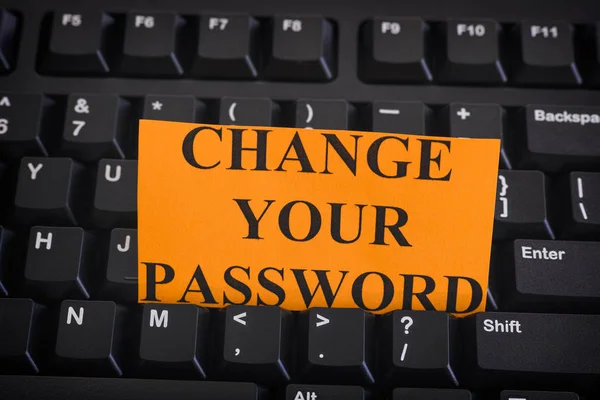 Paper note with phrase Change Your Password on black computer ke — Stock Photo, Image