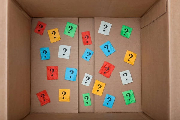 Знаки питання всередині картонної коробки — стокове фото