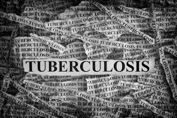 Torn pieces of paper with the word Tuberculosis — Stock Photo, Image