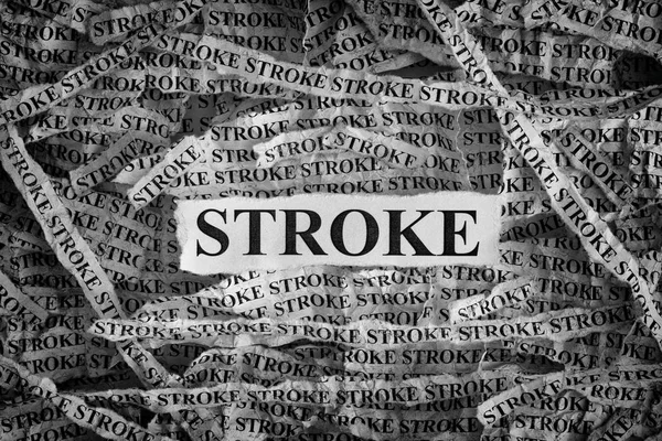 Un derrame. Trozos de papel rasgados con la palabra Stroke — Foto de Stock