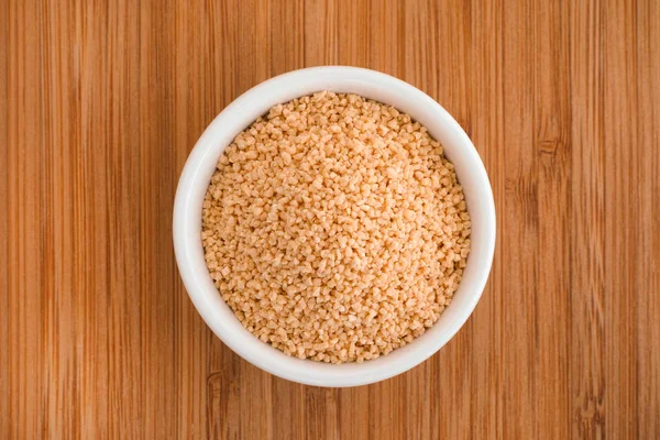 Soy lecithin in a bowl on a wooden background — Stock Photo, Image