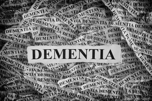 Torn pieces of paper with the word Dementia — Stock Photo, Image