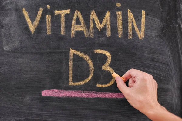 Hand writing Vitamin D3 on chalkboard — Stock Photo, Image