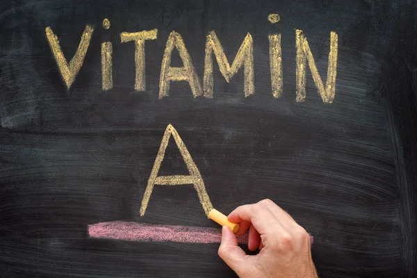 Hand writing Vitamin A on chalkboard — Stock Photo, Image