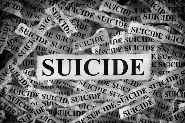 Torn pieces of paper with the words Suicide — Stock Photo, Image