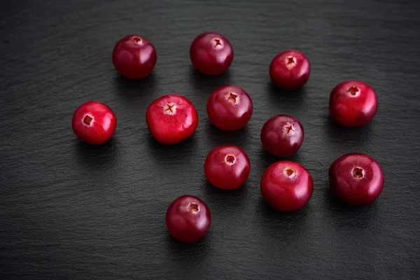 Cranberries on a black background — Stock Photo, Image