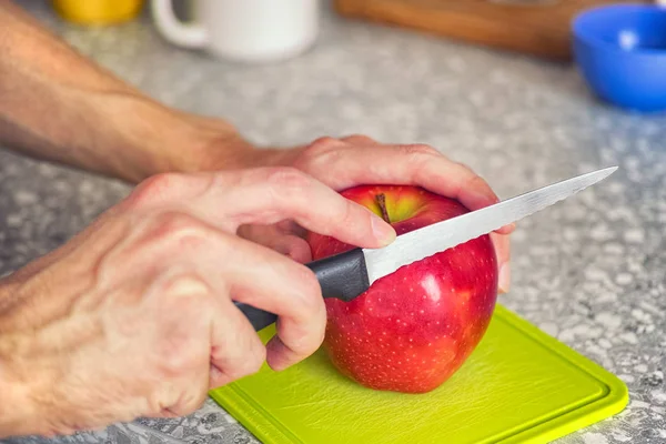 Person cutting an apple — Stock Photo, Image