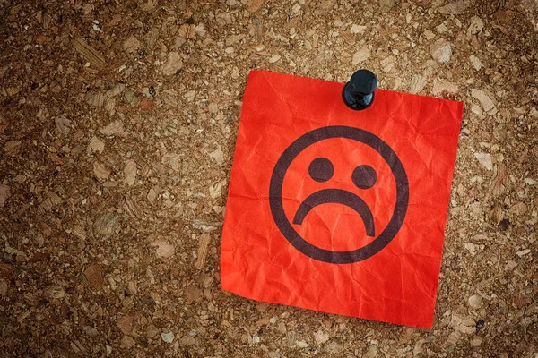 Red Paper Note Sad Face Cork Board Background Closeup — Stock Photo, Image