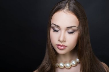 İnci kolyeli kadın.