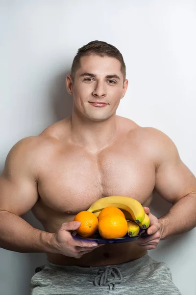 Man eats fruits — Stock Photo, Image