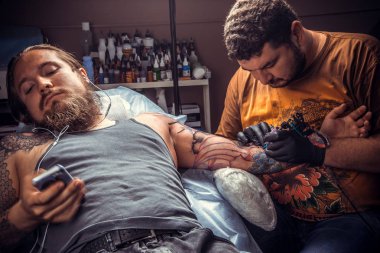 Tattooer çalışma studio. dövme / Master yapan dövme resimleri salonda.