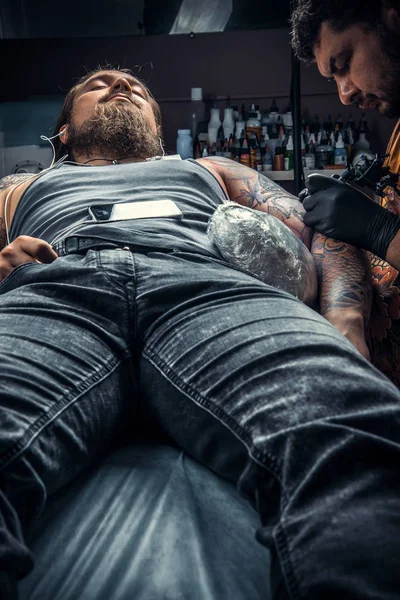 Tattoo specialist makes cool tattoo in tattoo parlor