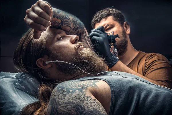 Tattooist create tattoo in studio