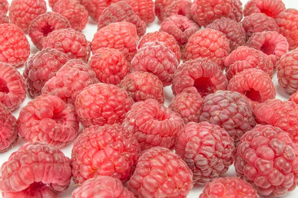 Fresh raspberries scattered on white background — Stock Photo, Image