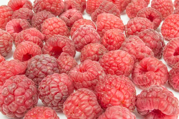 Fresh raspberries scattered on white background — Stock Photo, Image
