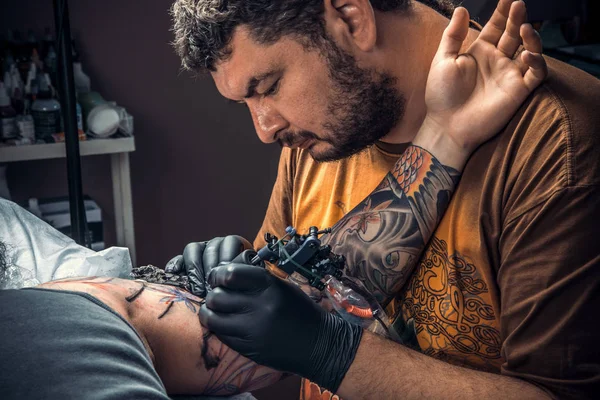 Professionell tatuerare på jobbet i studio — Stockfoto