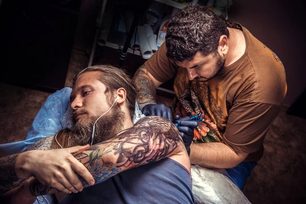 Tattoo specialist create tattoo in tattoo studio
