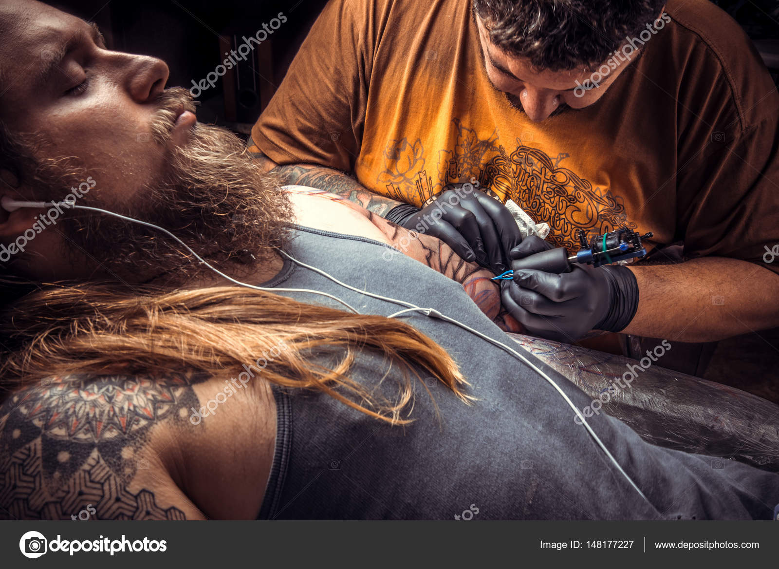 Tattoo master works in tattoo parlor Stock Photo by ©Stop war in Ukraine! 148177227 Tattoo master works in tattoo parlor Stock Photo by ©Stop war in Ukraine! 148177227