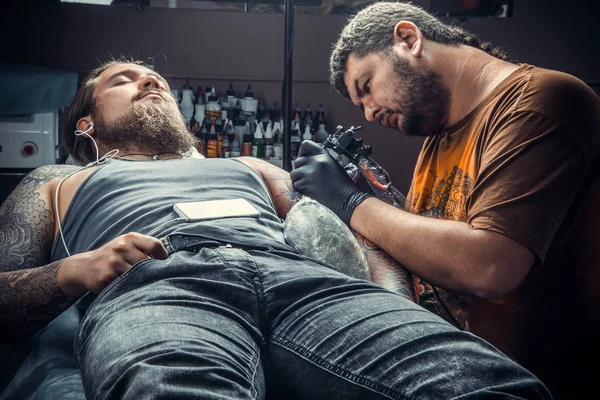 Tattoo artist posing in studio — Stock Photo, Image