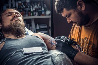 Profesyonel dövmeci tattoo studio içinde çalışır