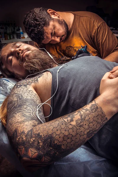 Tattoo specialist makes cool tattoo in tattoo parlor