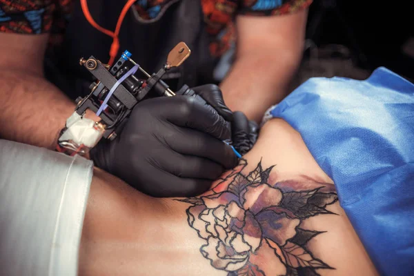 Master of the art of tattooing forms a tattoo — Stock Photo, Image