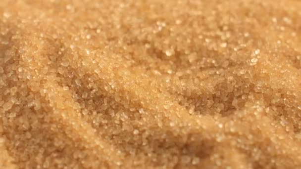 Κοντινό πλάνο καστανής υφής ζάχαρης. Ζάχαρη από ζαχαροκάλαμο ως φόντο — Αρχείο Βίντεο
