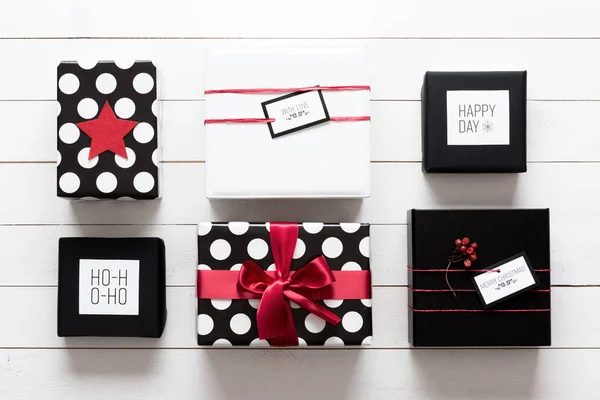 Muchos elegantes y bellamente envueltos regalos de Navidad en blanco, rojo y negro — Foto de Stock