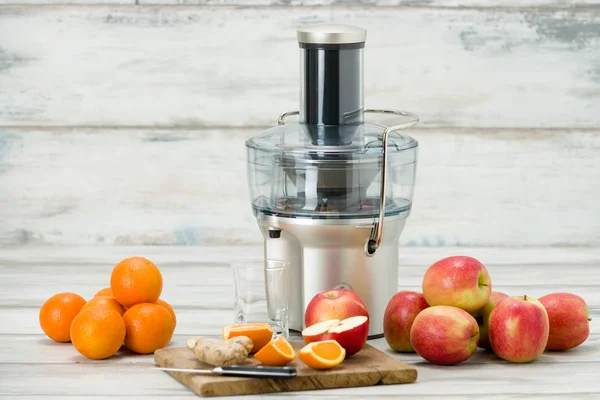 Modern electric juicer and various fruit on kitchen counter, healthy lifestyle concept — Stock Photo, Image