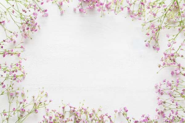 White wooden table with pink flowers, welcome spring concept — Stock Photo, Image