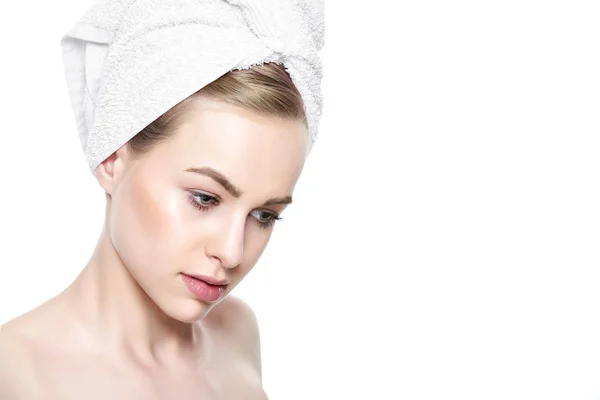 Bela jovem loira com pele perfeita e seu cabelo envolto em uma toalha. Cosmetologia, beleza e conceito de spa. Isolado sobre fundo branco . — Fotografia de Stock