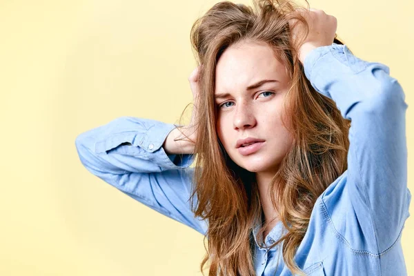 Young distraught redhead teenager with freckles pulling her hair. Tired stressed and depressed female student. Negative emotions, depression concept. — Stock Photo, Image