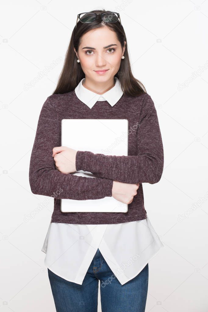 Happy student life. Attractive cheerful young female student holding digital tablet, isolated on white background. Education concept